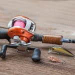 A close look of a baitcaster on a wooden surface from Freepik.