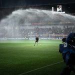 A look at the soccer field being sprayed with water in preparation for the match.